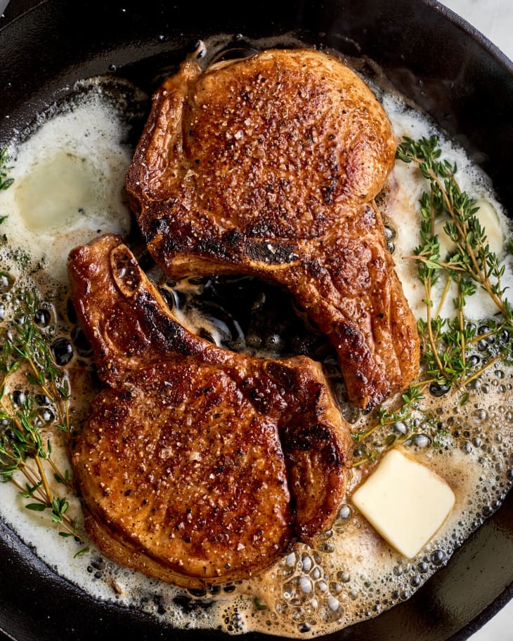 pork chops in a skillet with butter and thyme