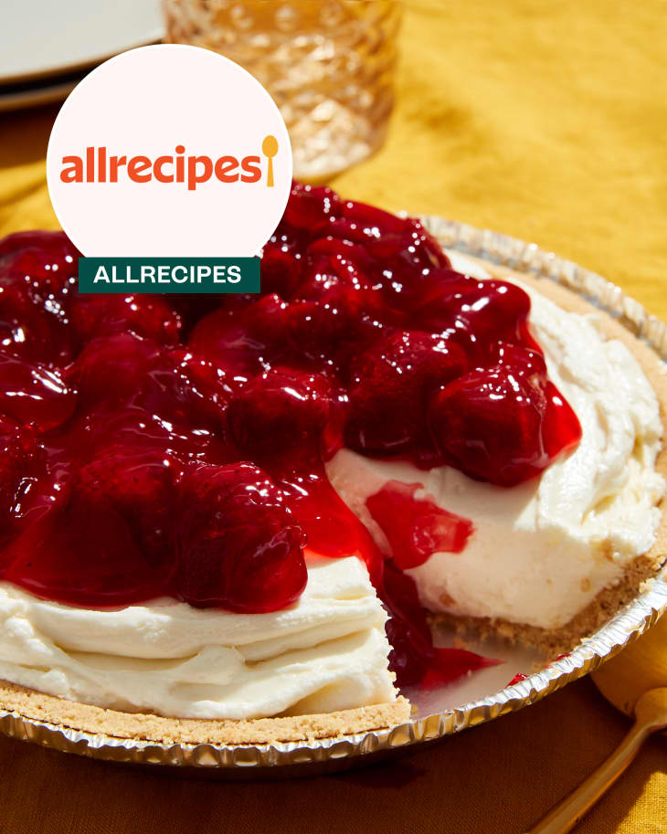 Cheesecake on plate with fork and water labeled 'Allrecipes'.