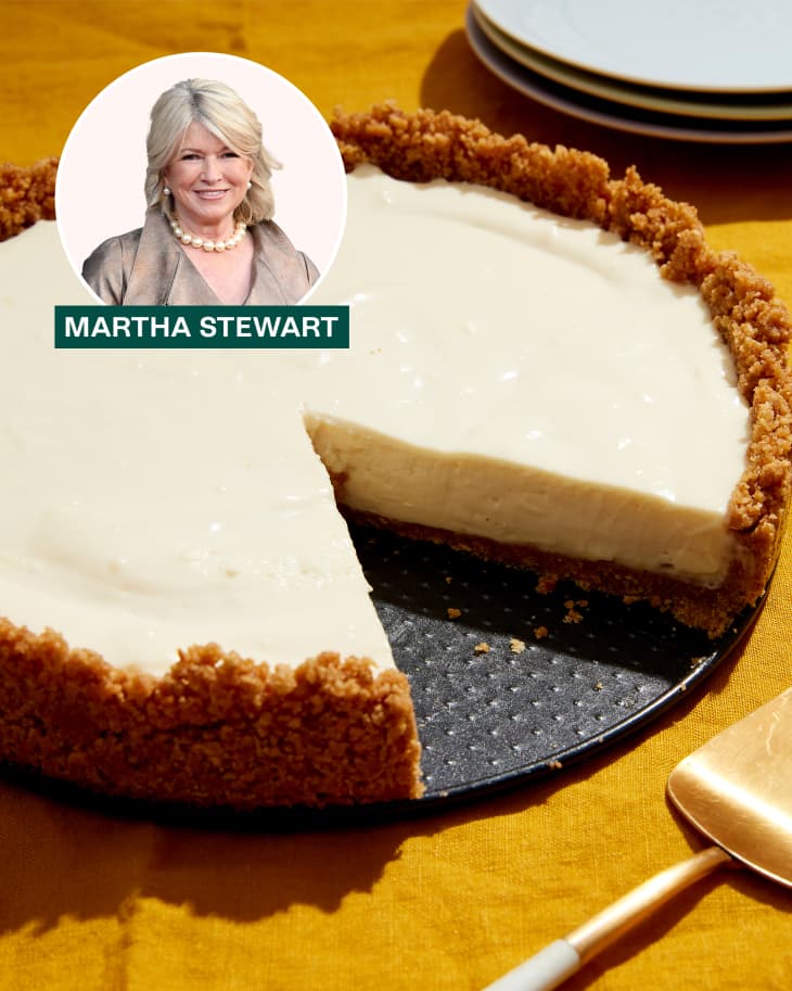 Cheesecake on plate with fork and water labeled 'Martha Stewart'.