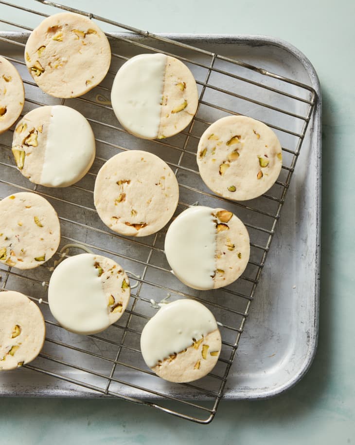 pistachio milk cookies dipped and on a cooling rack
