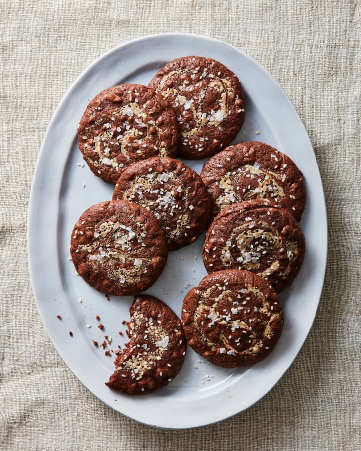 salted tahini brownie cookies on a platter on linen