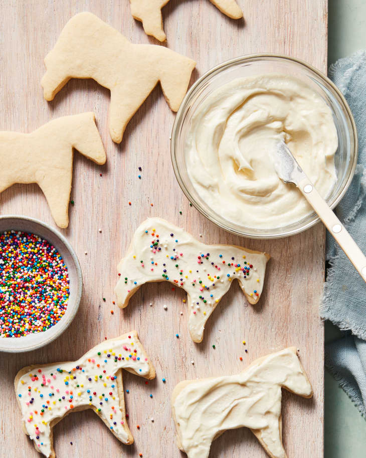 sugar cookies in horse shape on cutting board