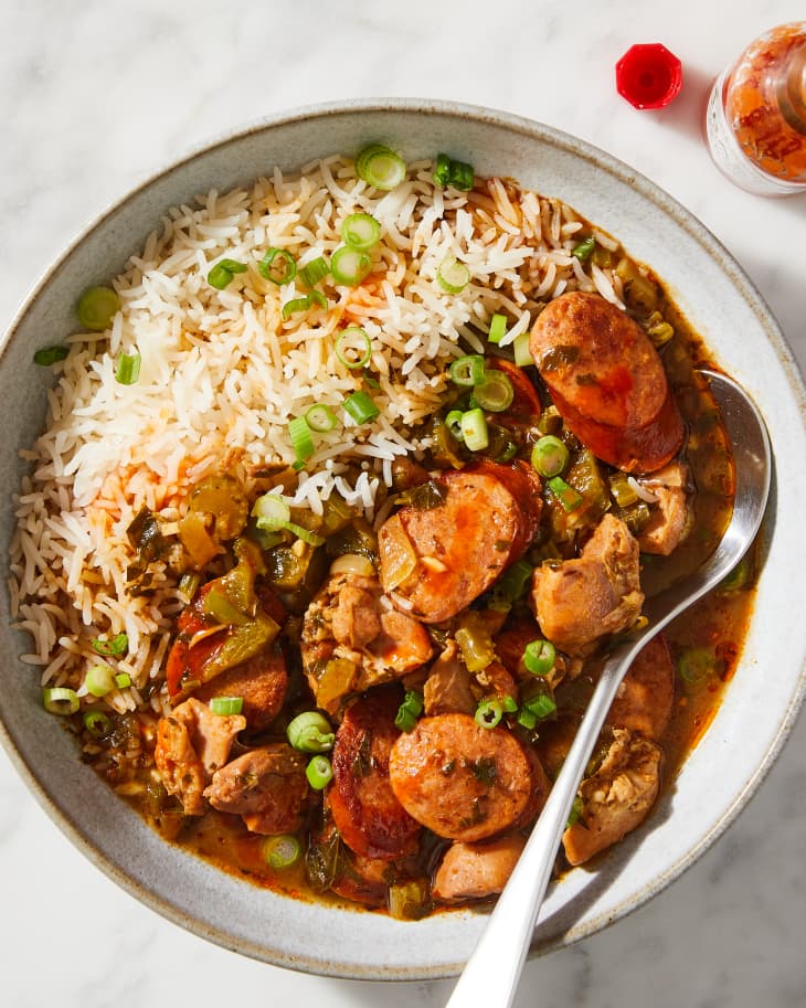 gumbo in a bowl with jasmine rice and a spoon