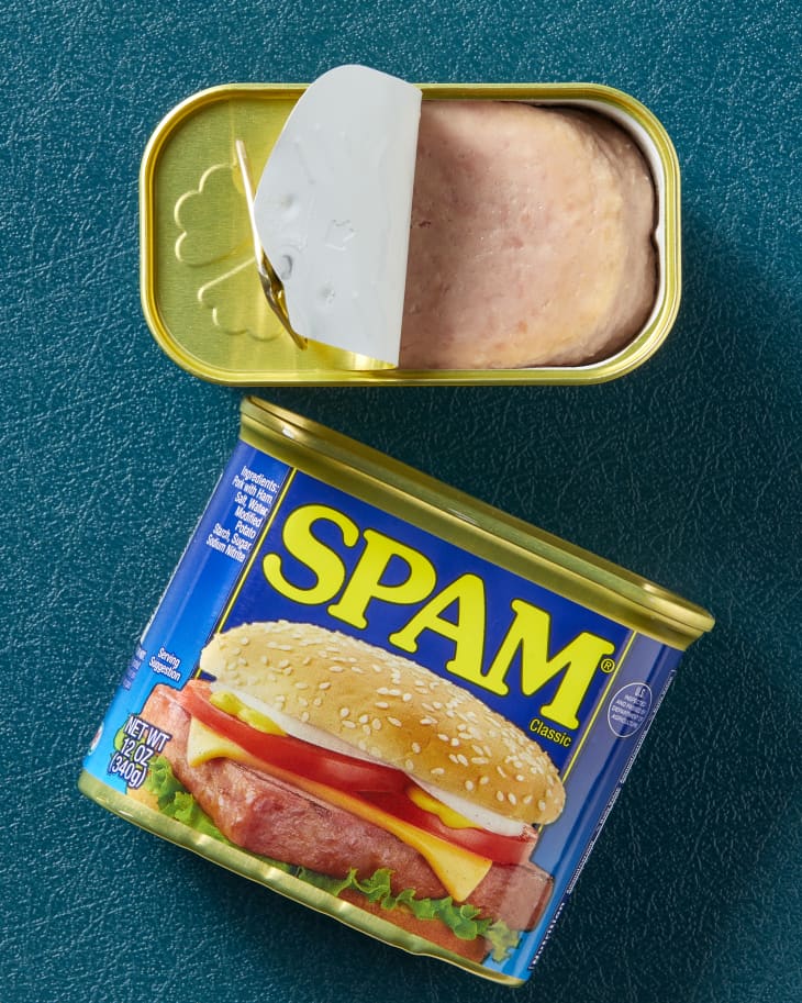 Overhead view of two cans of spam, one open and one closed, on its side.