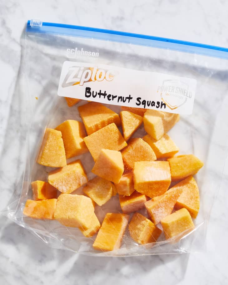 Cubed, frozen butternut squash in plastic freezer bag.
