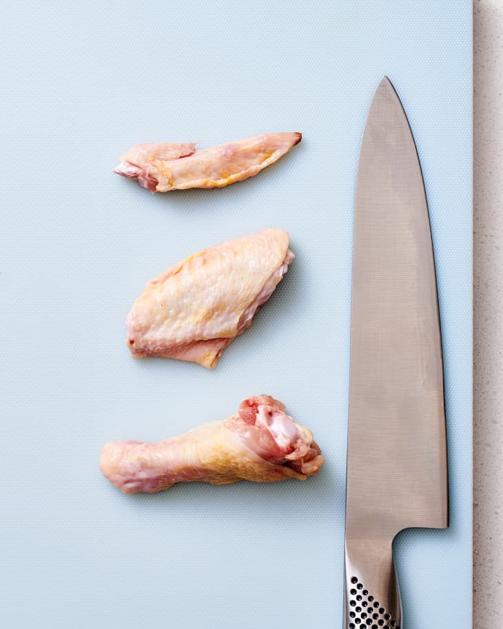 Drumstick, wingette and tip on cutting board.