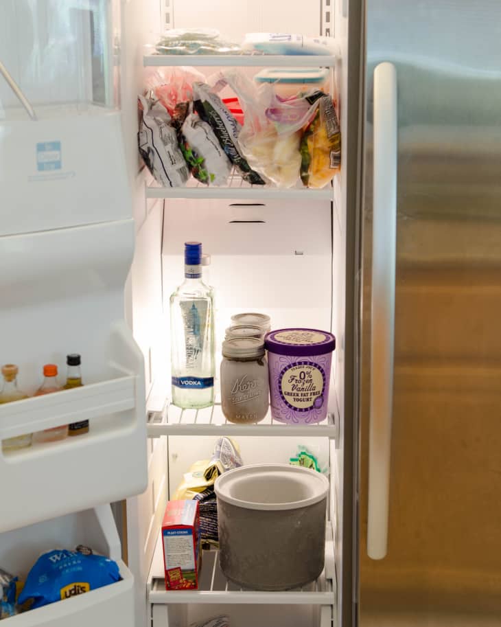 Perishable food products, including yogurt, frozen food, are kept in one side of the refrigerator