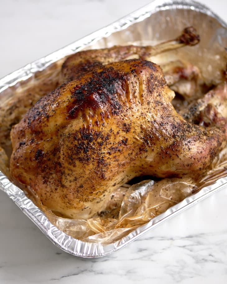 Roast turkey in a bag in a foil tray.