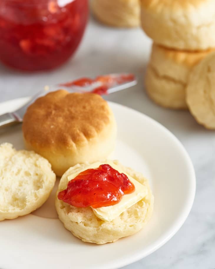 No-cook strawberry jam over a slice of butter on one side of a biscuit