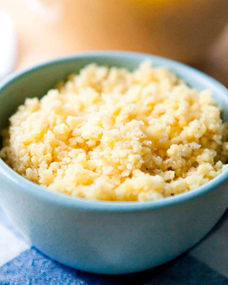 Cooked millet in a small blue bowl