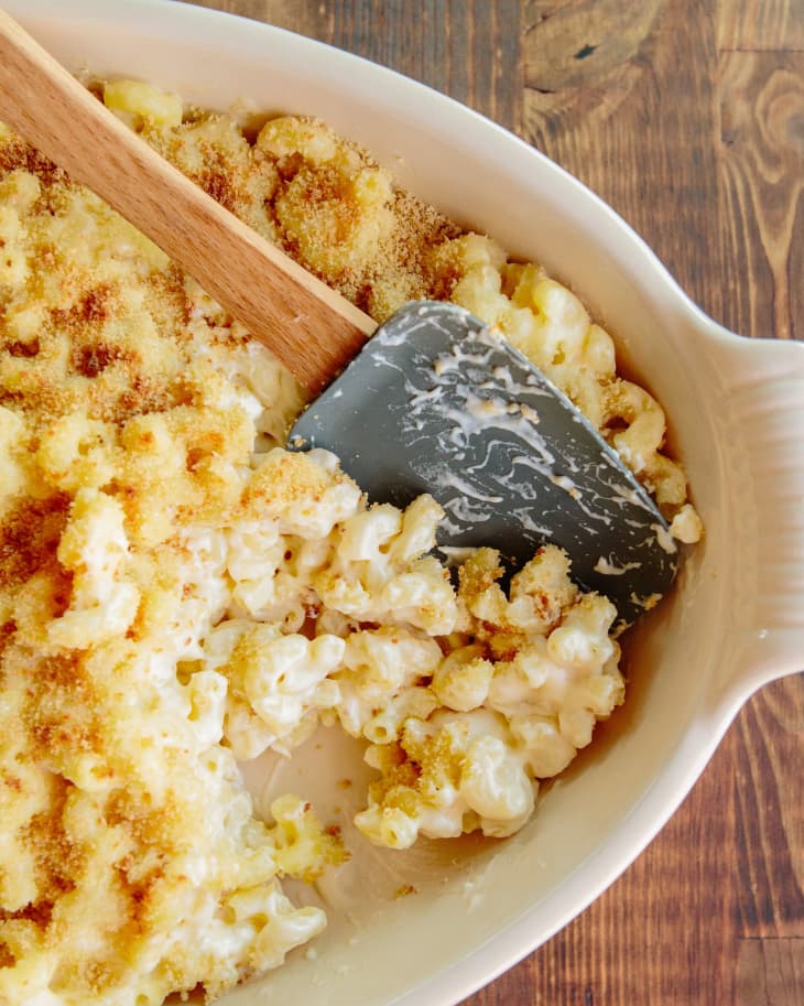 Baking dish filed with baked mac and cheese, some scooped out to show contrast between toasted panko topping and creamy interior