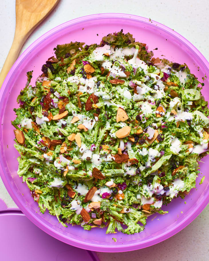 Broccolli salad with sliced almond, dried currants, and red onions, drizzled with mayonnaise dressing