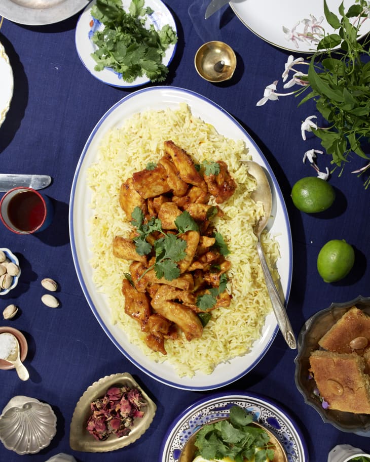 A table with for a feast featuring a platter of Chicken 65 with rice