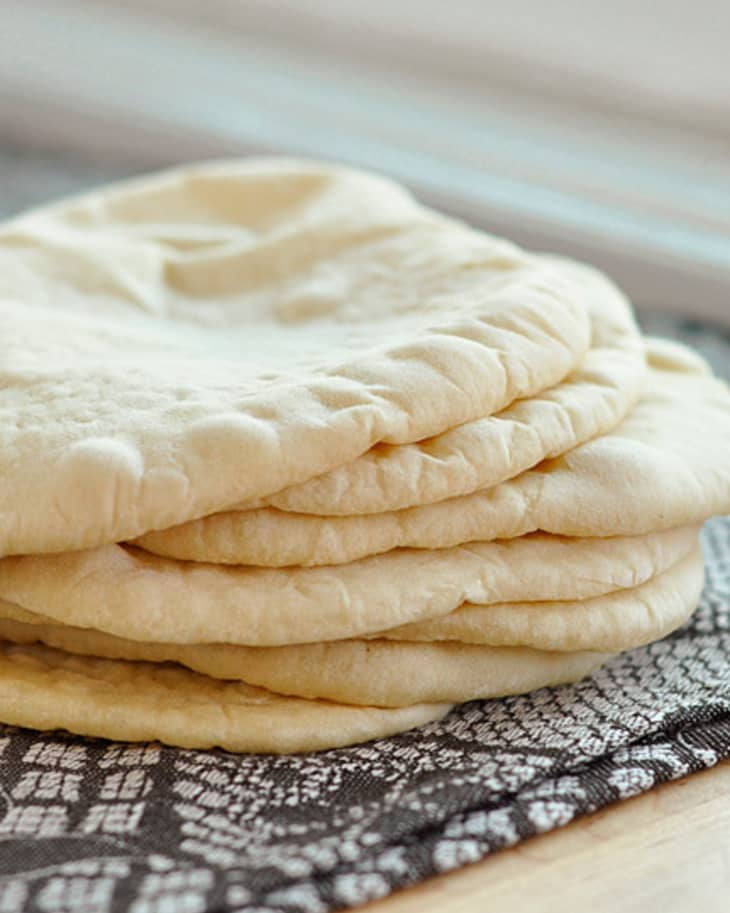 A stack of seven rounds of homemade pita bread