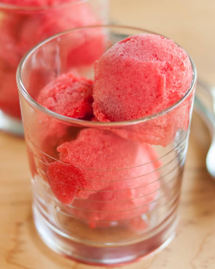 Three scoops of raspberry-rosé sorbet in a glass