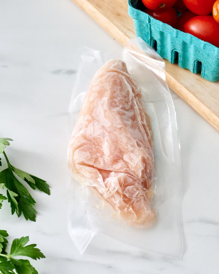 Frozen meat in a plastic bag. A piece of frozen meat wrapped in a