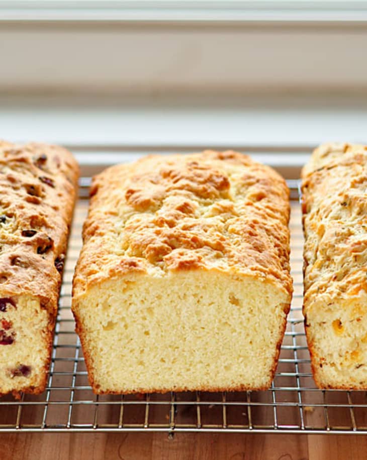 Loaves of bread are lined up on a rack