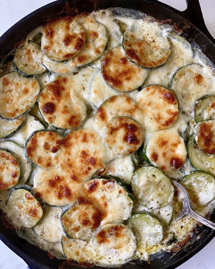 zucchini, parmesan, skillet, round zucchini slices, browned cheese, crispy top, creamy base, metal spoon