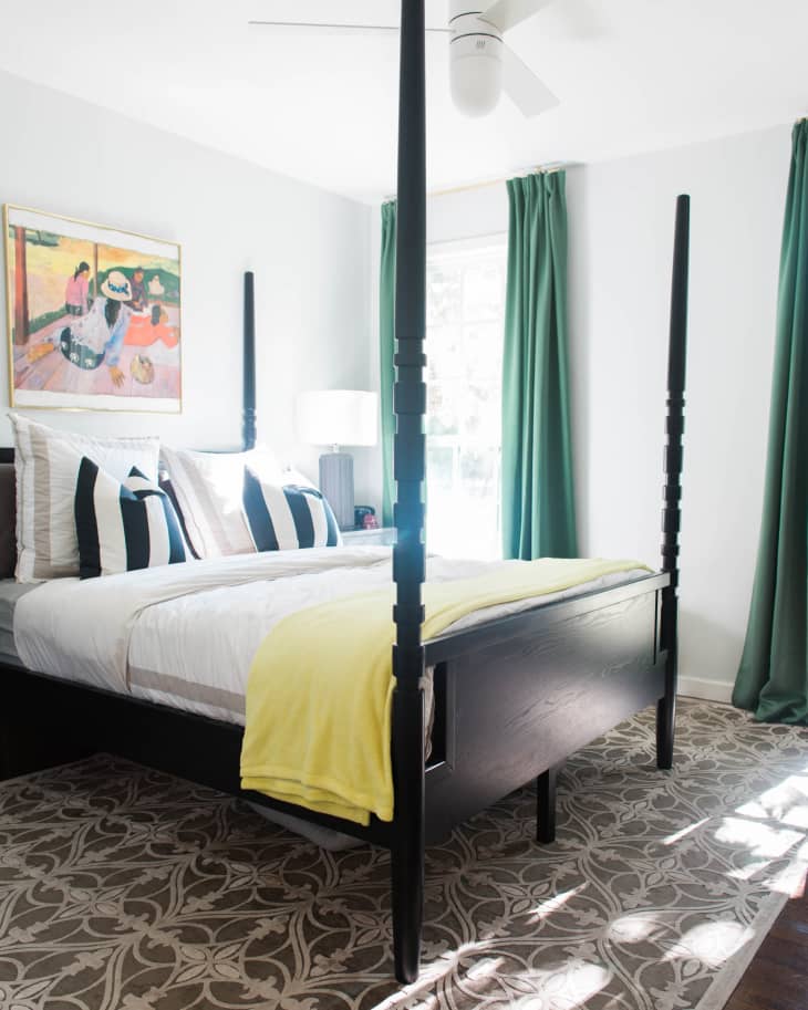 emerald window treatments and a white wall in a bedroom with a four-poster bed
