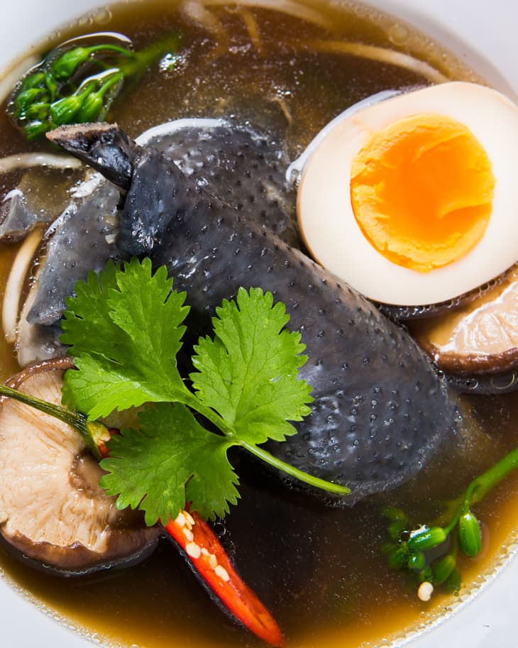 Directly above view of fresh healthy meal in bowl. Close-up of Silkie chicken noodle soup. It is served on table.