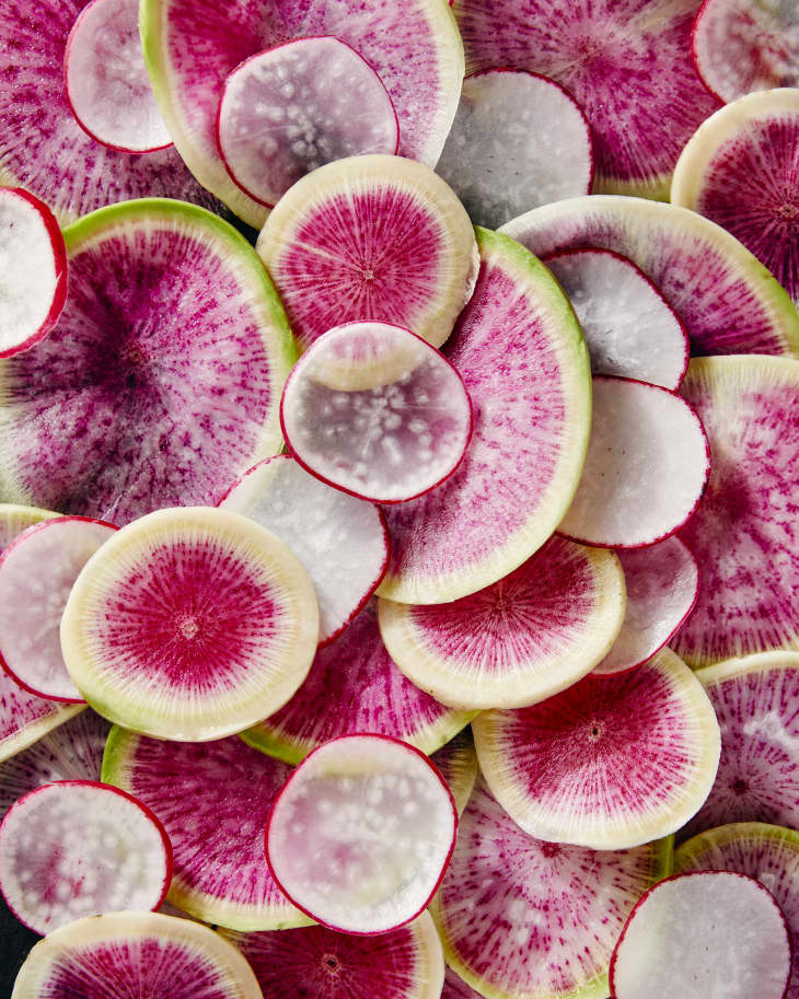 still life overhead view of sliced watermelon radishes and red radishes