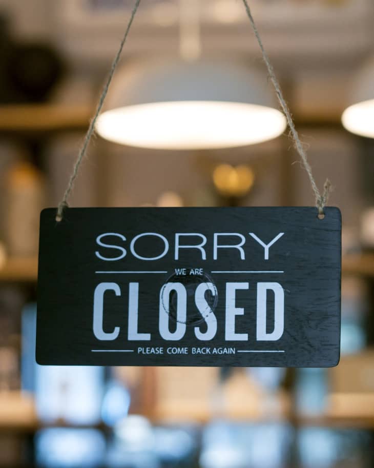 Closed sign hanging in business window