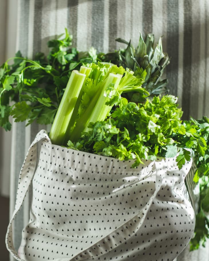 Reusable shopper with vegetables, fruits and products.