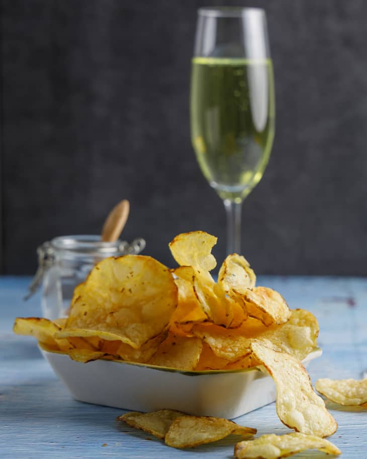 Homemade crisps, chips made from vegan potatoes fried in sunflower oil. With champagne .