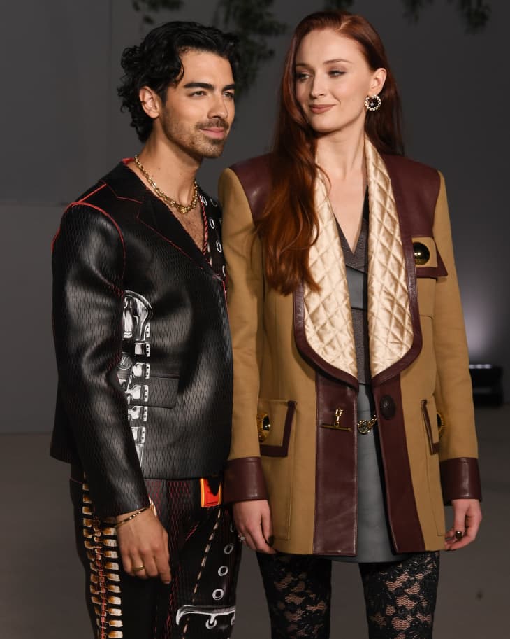 Joe Jonas and Sophie Turner outdoors at nighttime event, posing for cameras