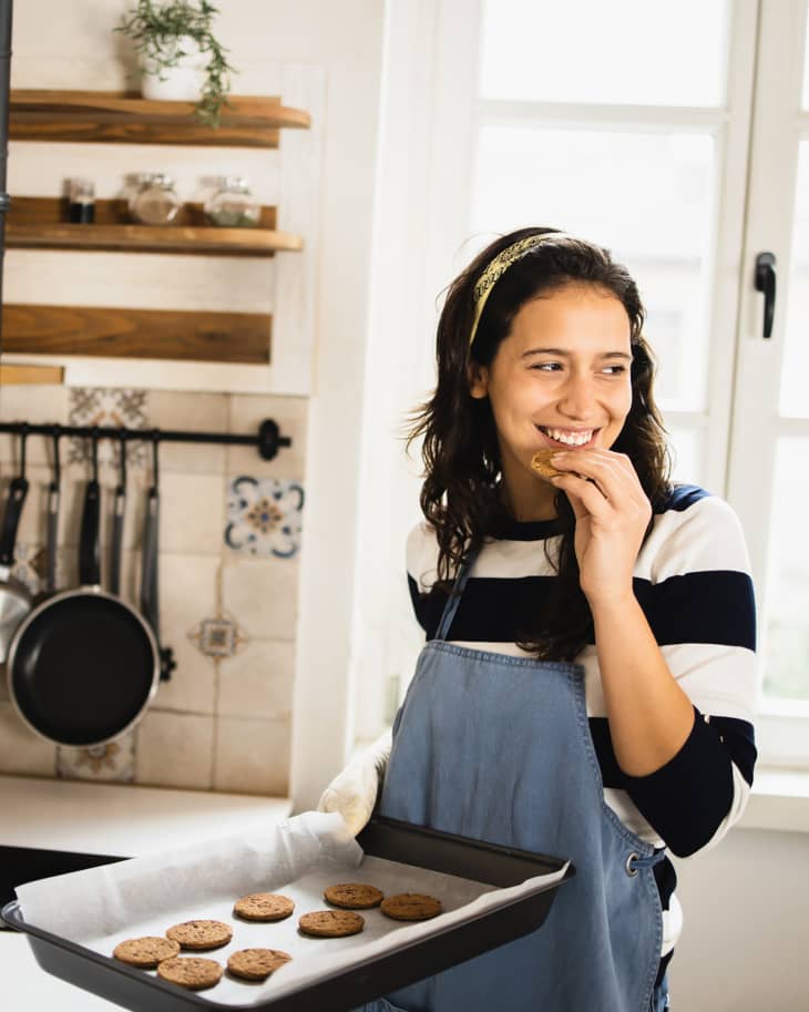 Young woman baking cookies at her kitchen