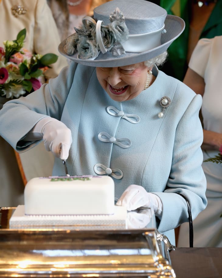 JUNE 04: Sophie, Countess of Wessex and Princess Anne, Princess Royal look on as Queen Elizabeth II cuts a Women's Institute Celebrating 100 Years cake at the Centenary Annual Meeting of The National Federation Of Women's Institute at the Royal Albert Hall on June 4, 2015 in London, England.