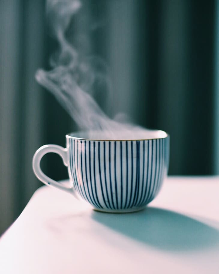 Close-Up Of Steaming Coffee Cup On Table