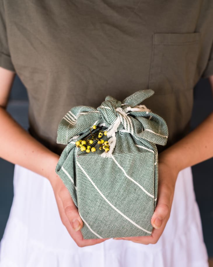 Woman holding furoshiki wrapped gift