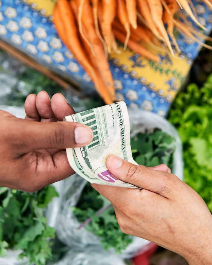 Paying for fresh produce at the farmers market.