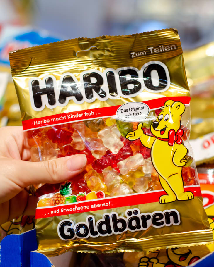 Hand taking pack of Haribo Bears gummy candy.