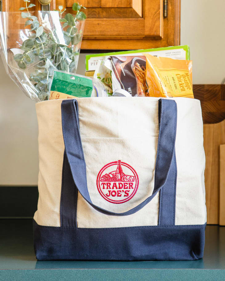 Canvas bag filled with Trader Joe's groceries on countertop.