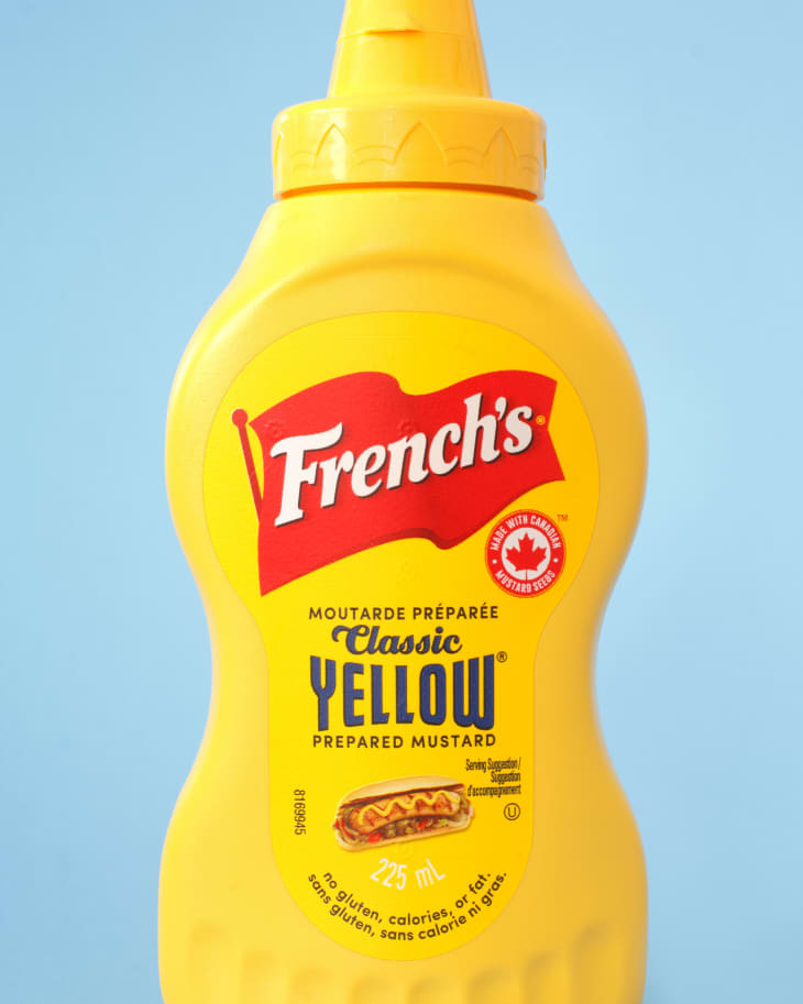 French's Mustard bottle on blue. French’s is a U.S. brand of mustard and various other food products.