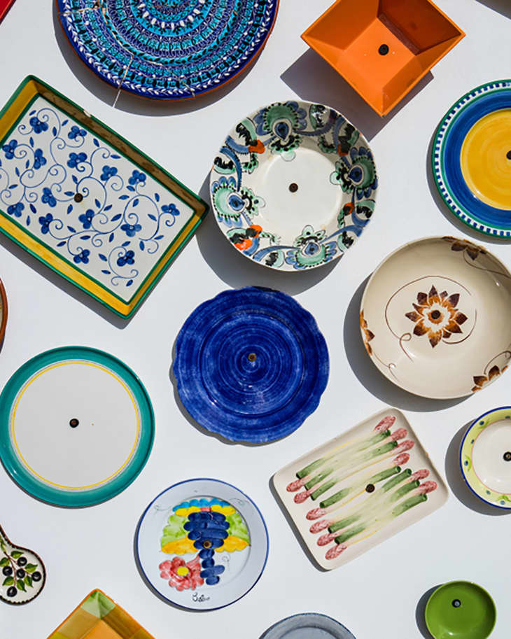 Collection of colorful Portuguese ceramic pottery, local craft products from Portugal. Ceramic plates display in Portugal. Colorful of vintage ceramic plates in Sagres, Portugal.