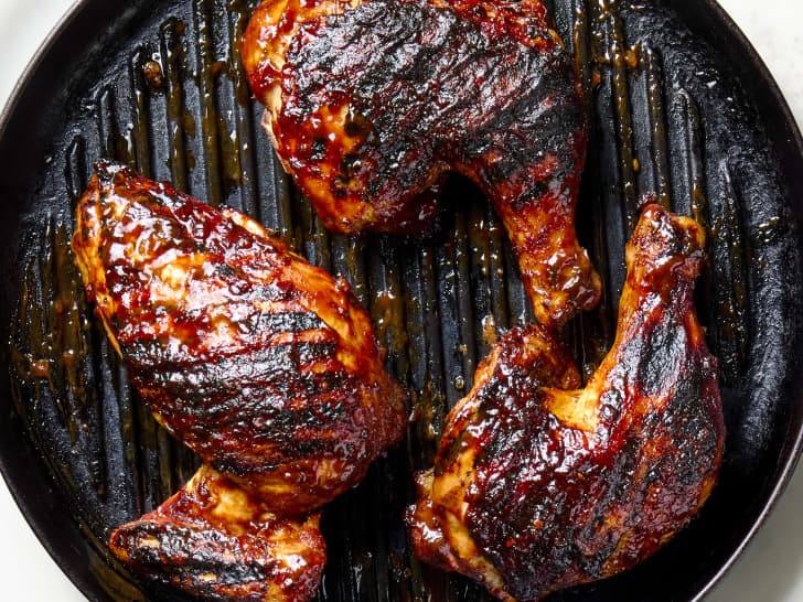 overhead shot of three pieces of BBQ chicken in a grill pan,using Ina Garten's recipe