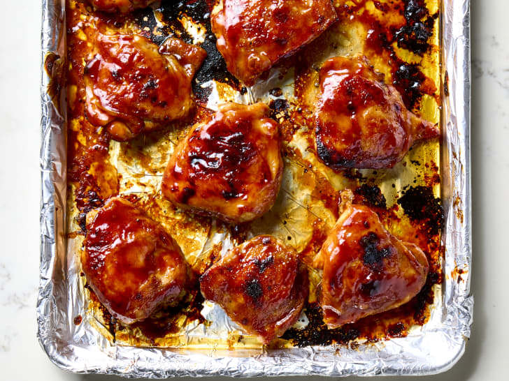 overhead shot of Ree Drummond BBQ chicken thighs  on a sheet pan