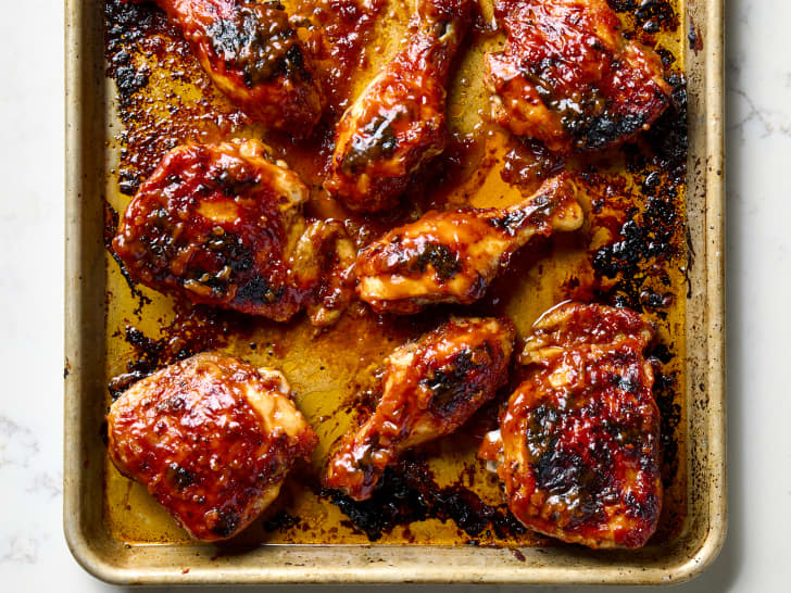 overhead shot of Tricia Yearwood's BBQ chicken thighs and wings on a sheet pan