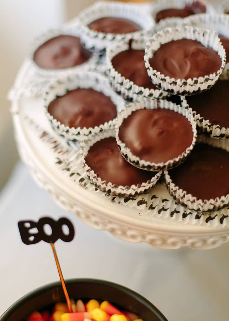 Image 4: Chocolate peanut butter cups on a decorative stand, with a "Boo" sign and candy corn nearby.