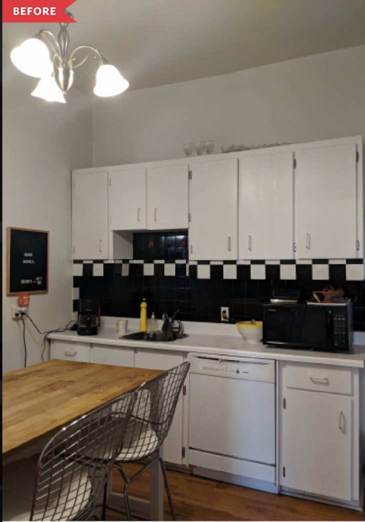 Kitchen with white cabinets, black and white checkered backsplash, wooden island, and metal chairs.