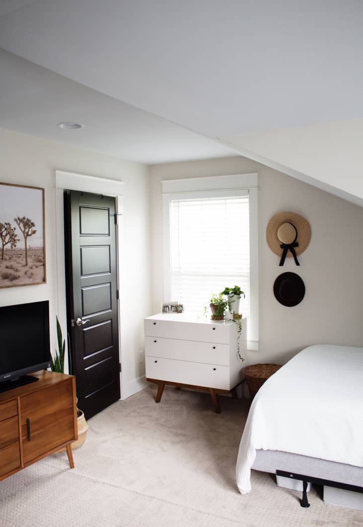 Minimal garage apartment bedroom with mid-century furniture