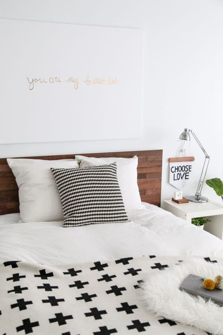 An Ikea malm bed with white and black geometric designs.