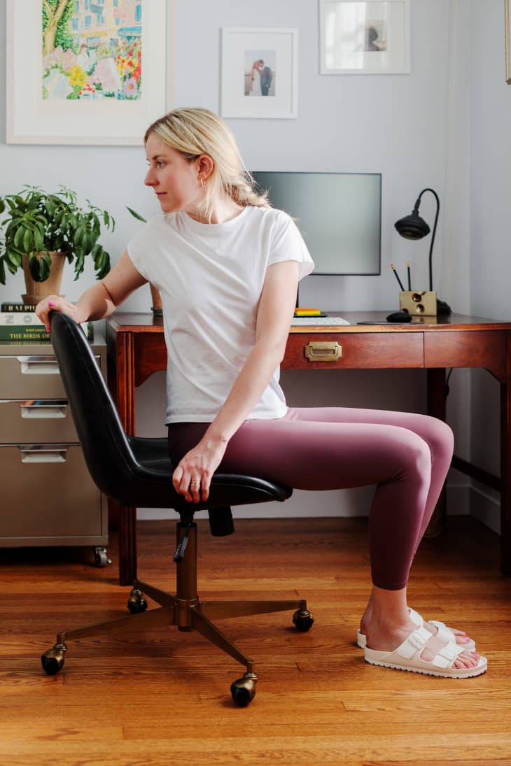 stretching back in chair at home office