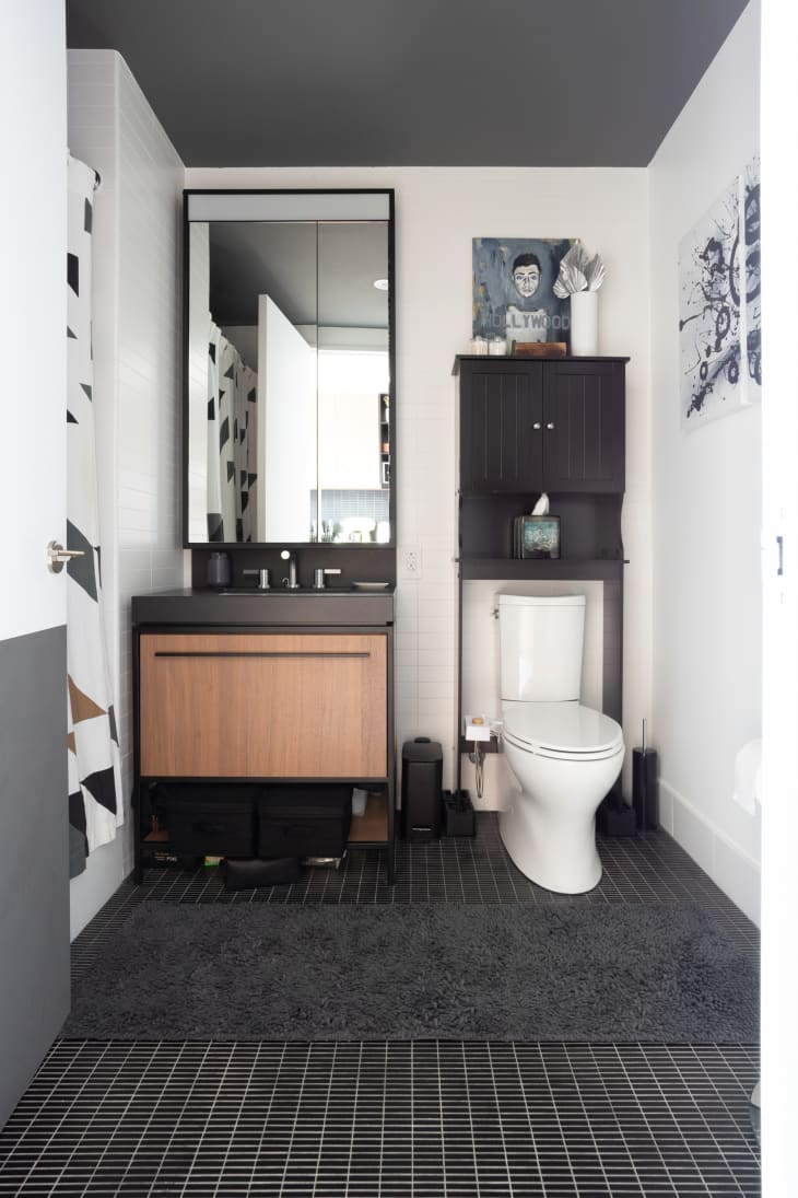 Bathroom with black floor, white walls, other black and white accents