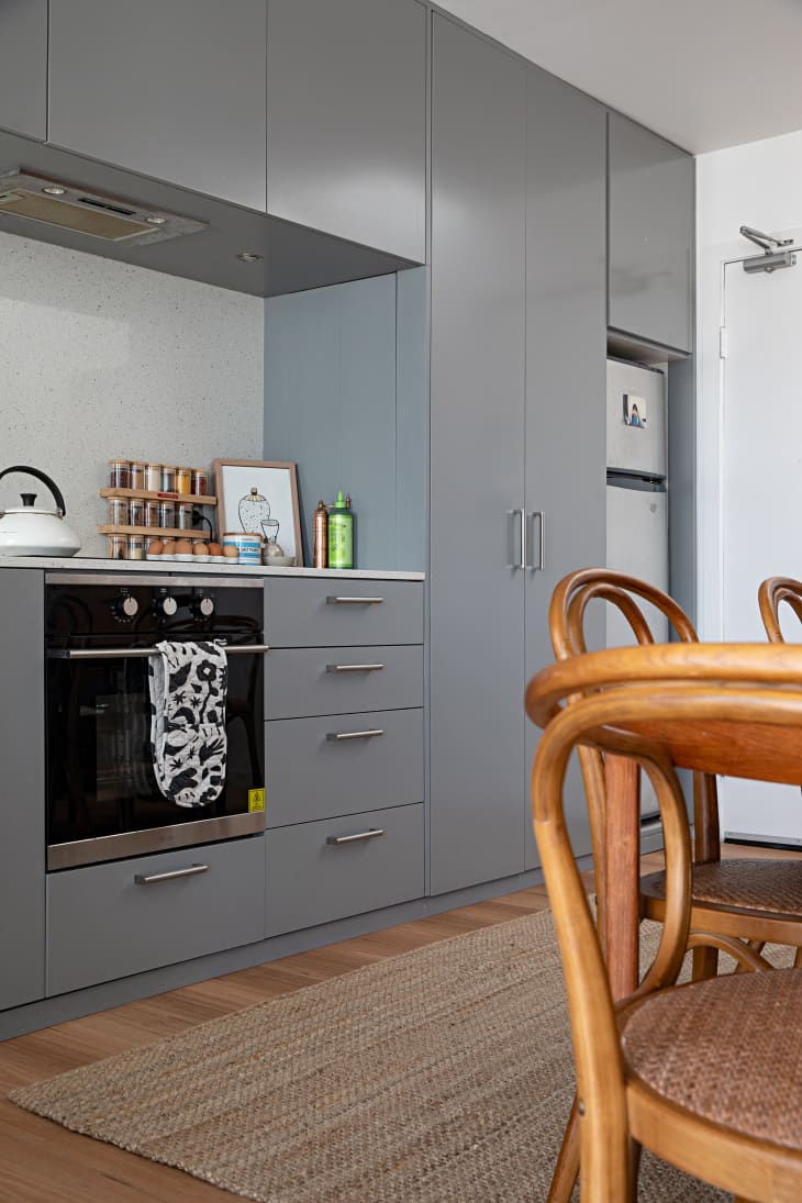 Gray cabinets in apartment kitchen.