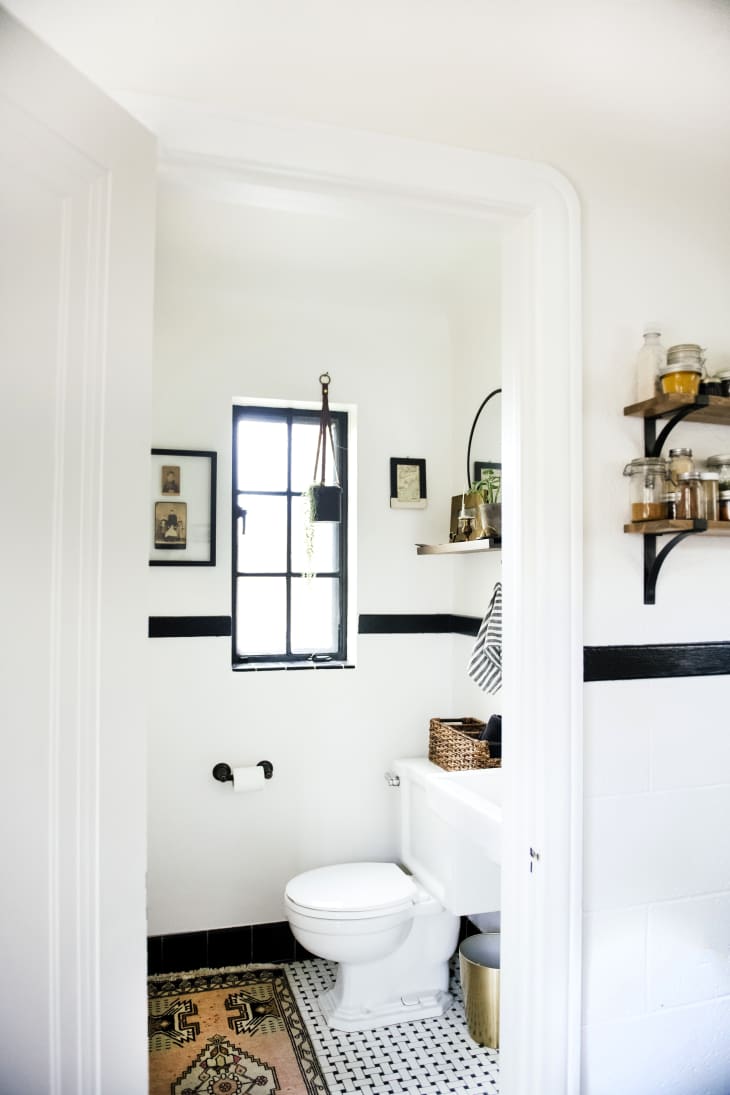 A white bathroom with white brick on the lower portion of the wall