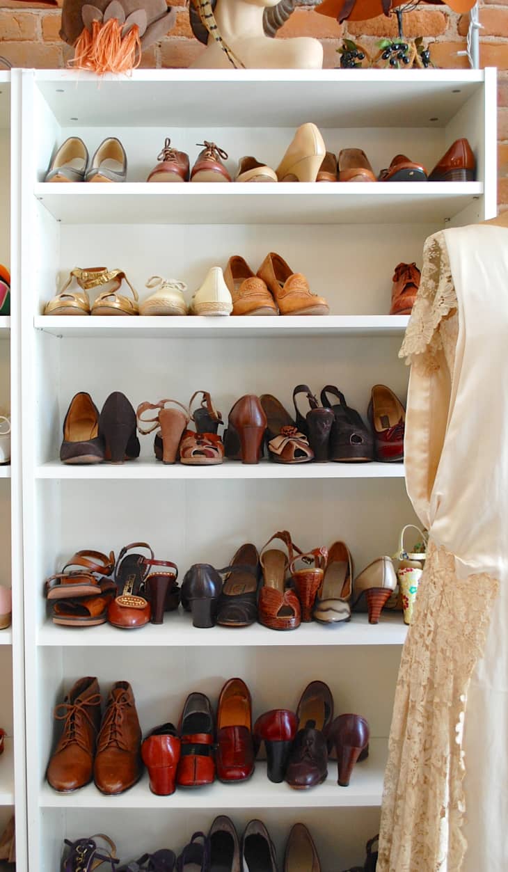 A six-tier shoe storage cabinet filled with different styles of shoes